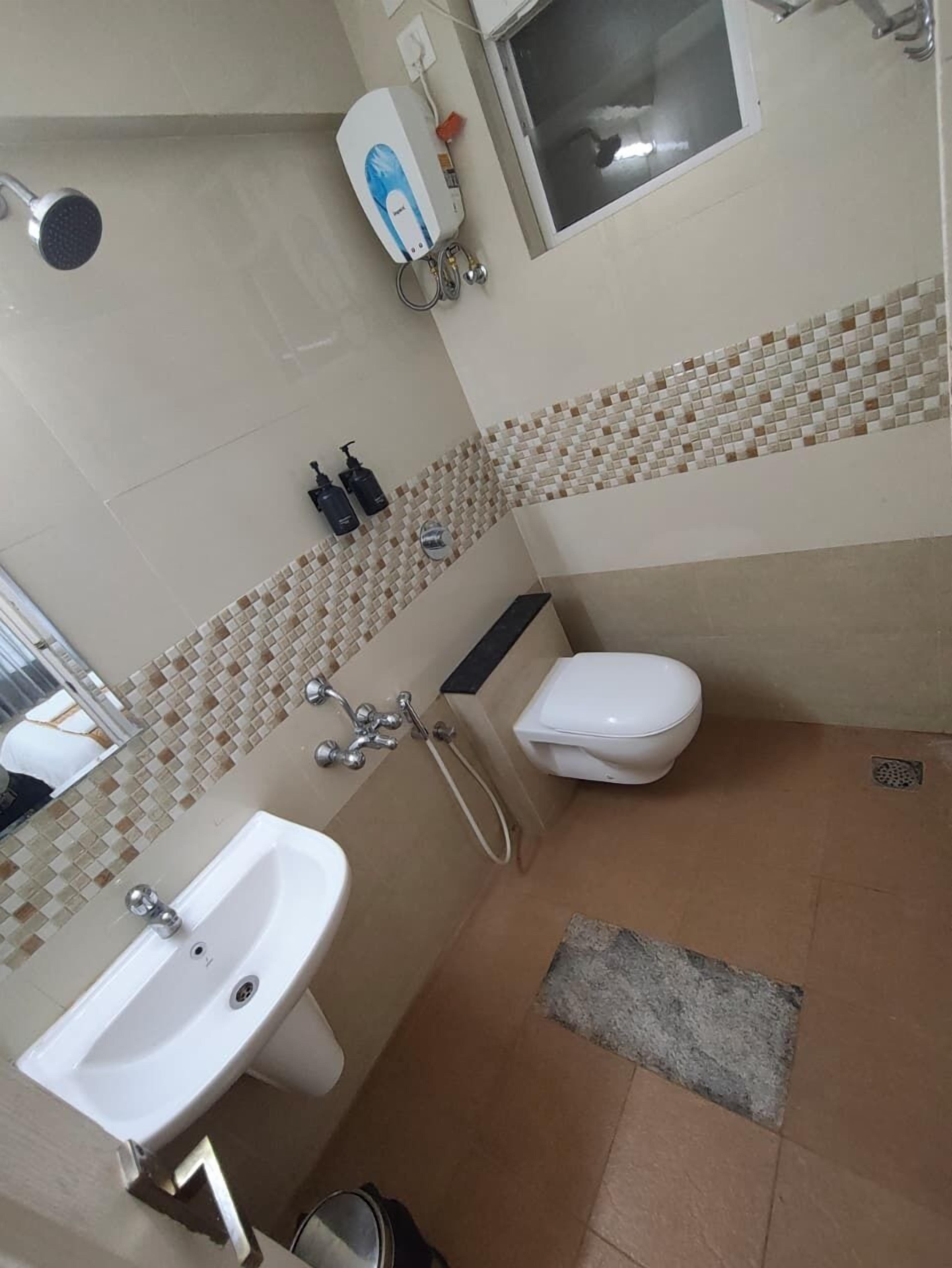 A bathroom with a sink, toilet, and shower.