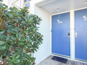A blue door with a keypad lock and a doormat. - Gulf-Front Villa A-6 Pool Access Sleeps 7 (Saint George Island)