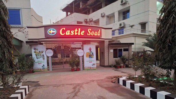 The entrance to Castle Soad with a prominent sign, a gated entrance, and potted plants around. - Hotel Castle Soad Bogura (Bogra)
