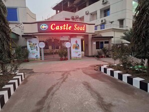 The entrance to Castle Soad with a prominent sign, a gated entrance, and potted plants around. - Hotel Castle Soad Bogura (Bogra)