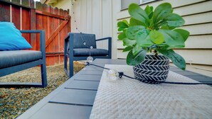 A patio area with a potted plant, a chair, and a table. - 5 Mi to Dtwn Riverside & Hospital! Remote-Work Hub (Riverside)
