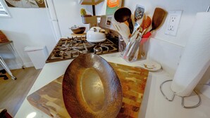 A kitchen with a large wooden bowl, a stove, and various utensils. - 5 Mi to Dtwn Riverside & Hospital! Remote-Work Hub (Riverside)
