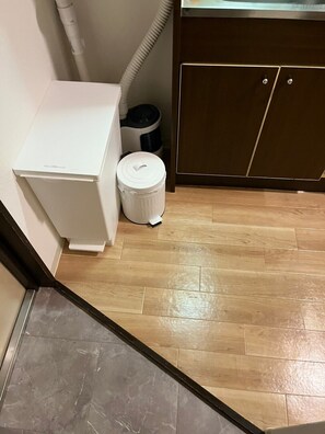 A small bathroom with a white toilet, a white trash bin, and a wooden floor. - 30sec walk to Tsutenkaku/1 stop to Namba Sta./AH23 (Ebisu Higashi Naniwa Ward,Osaka City)