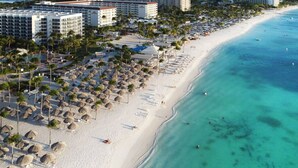 A beach resort with multiple hotel buildings, palm trees, and a sandy beach. - Conch Beach Villa NEW 7-Bed 6 Bath Pool 5-min to Beach by Bocobay (Noord)