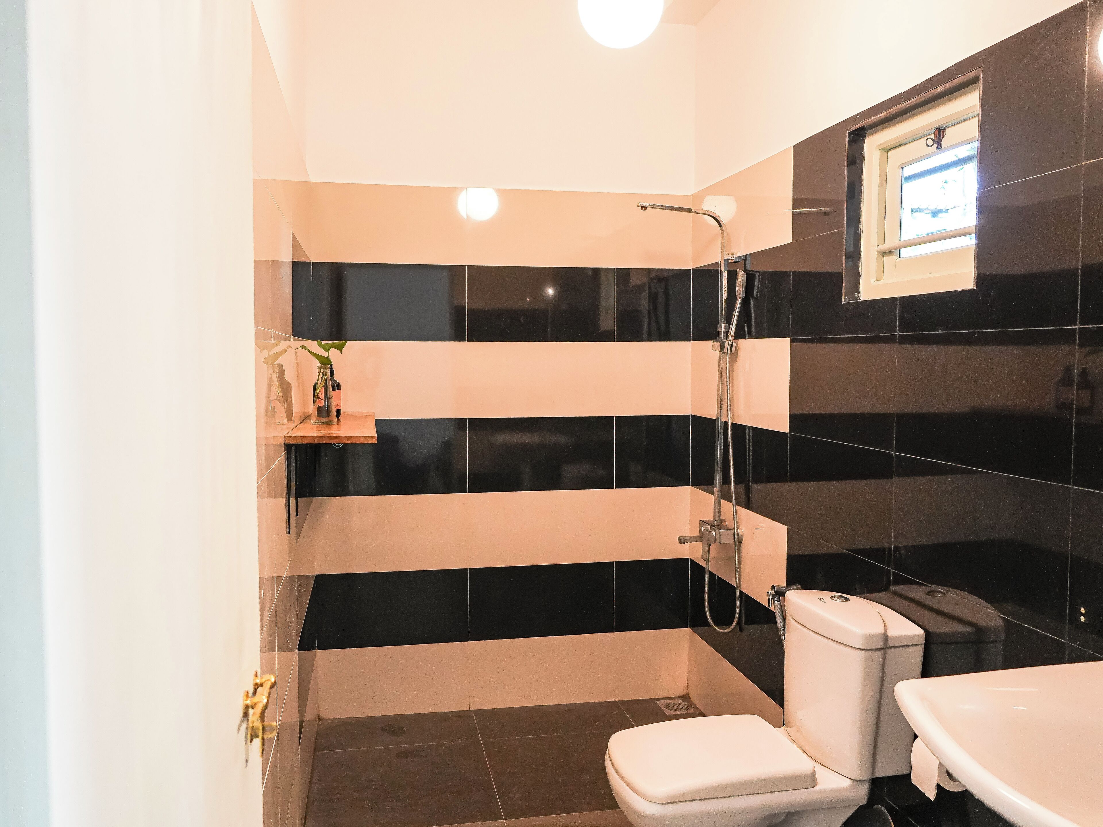 A bathroom with a toilet, a sink, and a shower.