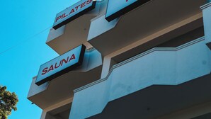 A building with signs for 'Pilates', 'Ice', 'SAUNA', and 'Yoga'. - Mira Mirissa  (Mirissa)