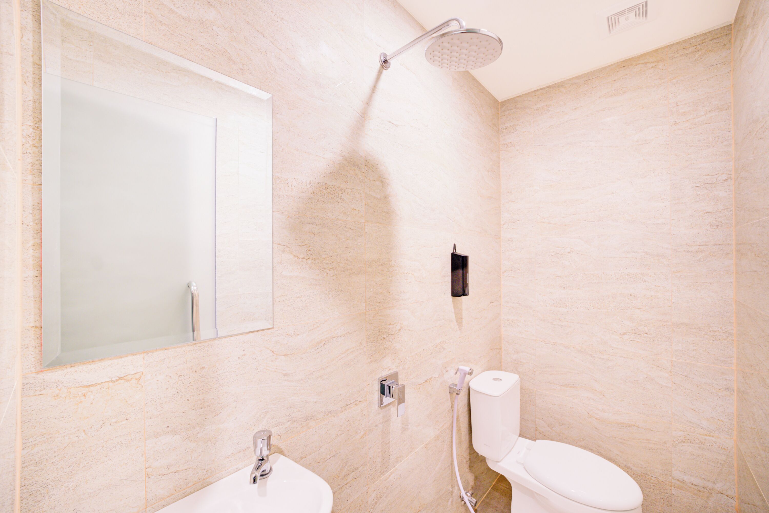 A bathroom with a shower, toilet, and sink.