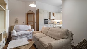 A compact living space with a sofa, a dining table, and a kitchenette. - Italianway Easy - Rosales 3 C (Milan)