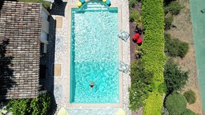 An aerial view of a rectangular swimming pool with clear blue water, surrounded by a stone wall and lush greenery. - 6-hectare estate classified as a Grand Site de France concors Sainte Victoire (Jouques)