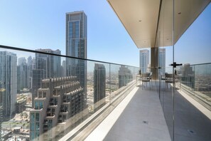 A high-rise building with a glass balcony overlooking a cityscape. - 2BR Steps to Burj Khalifa Dubai Mall (Dubai)