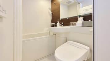 A modern bathroom with a shower, toilet, and sink.