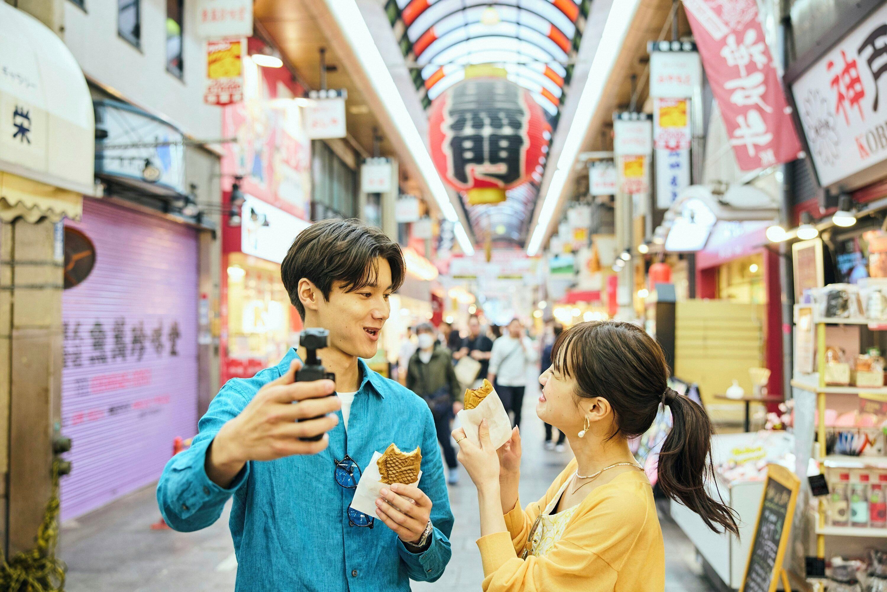 A bustling indoor market with various shops and signs.