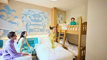 A room with bunk beds, a mural, and a bed with guests.
