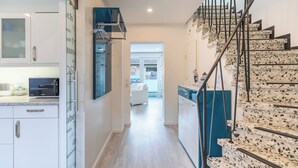 A modern kitchen with white cabinets and a built-in microwave. - Vacation home "Bellaeins" in Tönning for up to 4 people (Tönning)