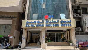 A hotel building with a prominent glass facade and a sign reading "Al-Olayah Golden Hotel". - Al Olayan Golden Hotel Misfalah (Makkah)