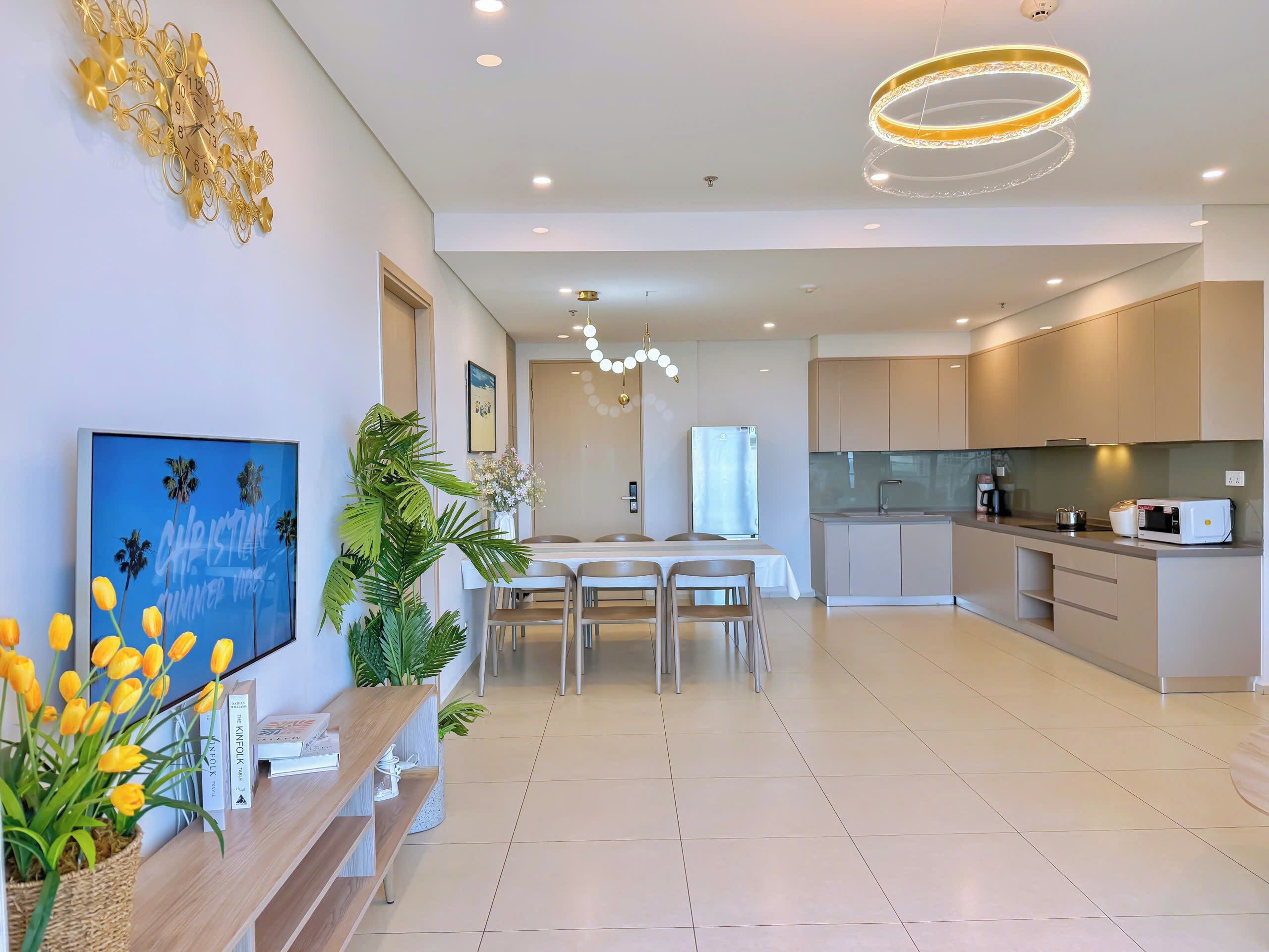A modern kitchen with a built-in oven, microwave, and sink.