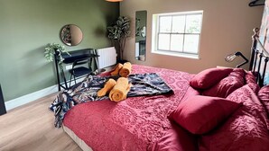 A bedroom with a bed, a desk, a chair, a window, and a hanging light fixture. - Large Period Property On The Edge Of City Centre. (Worcester)