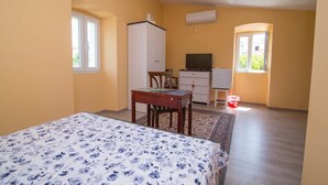 A bedroom with a bed, a desk, a chair, a wardrobe, and a television. - Luisa Rooms / Luisa room B2 (Veli Lošinj)