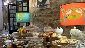 A buffet table with various food items and a decorative lamp. - Villa Miramì (Saturnia)
