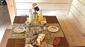 A breakfast table set with plates, glasses, and various food items. - Attractive guesthouse with spacious garden and extra service in the middle of nature (Lysvik)