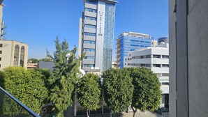A modern building with a glass facade and a sign that reads "VKRITICOS TOWER". - 116 NIC 303 - Stay Vintage Central Suites (Nicosia)