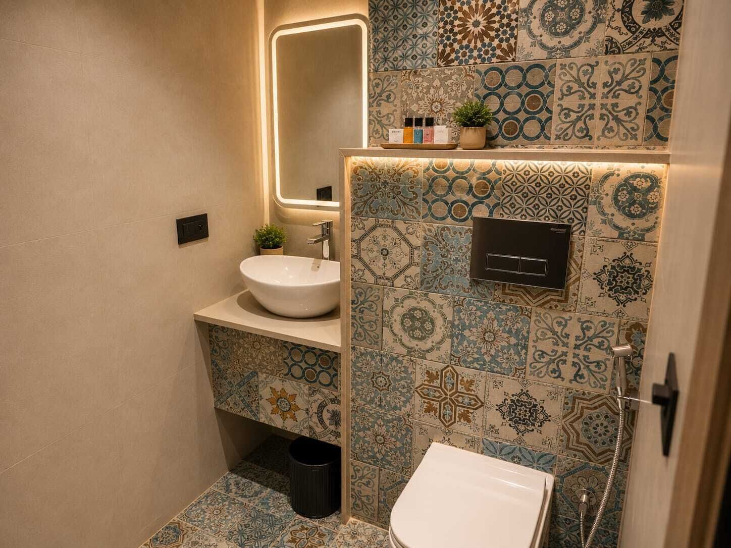 A bathroom with a white sink, a mirror, a toilet, and a shower.