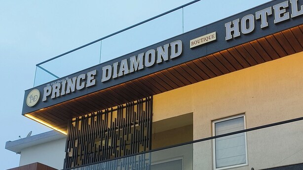The exterior of the Prince Diamond Boutique Hotel with a modern design, large glass windows, and a welcoming entrance. - Prince Diamond Boutique Hotel (Varanasi)