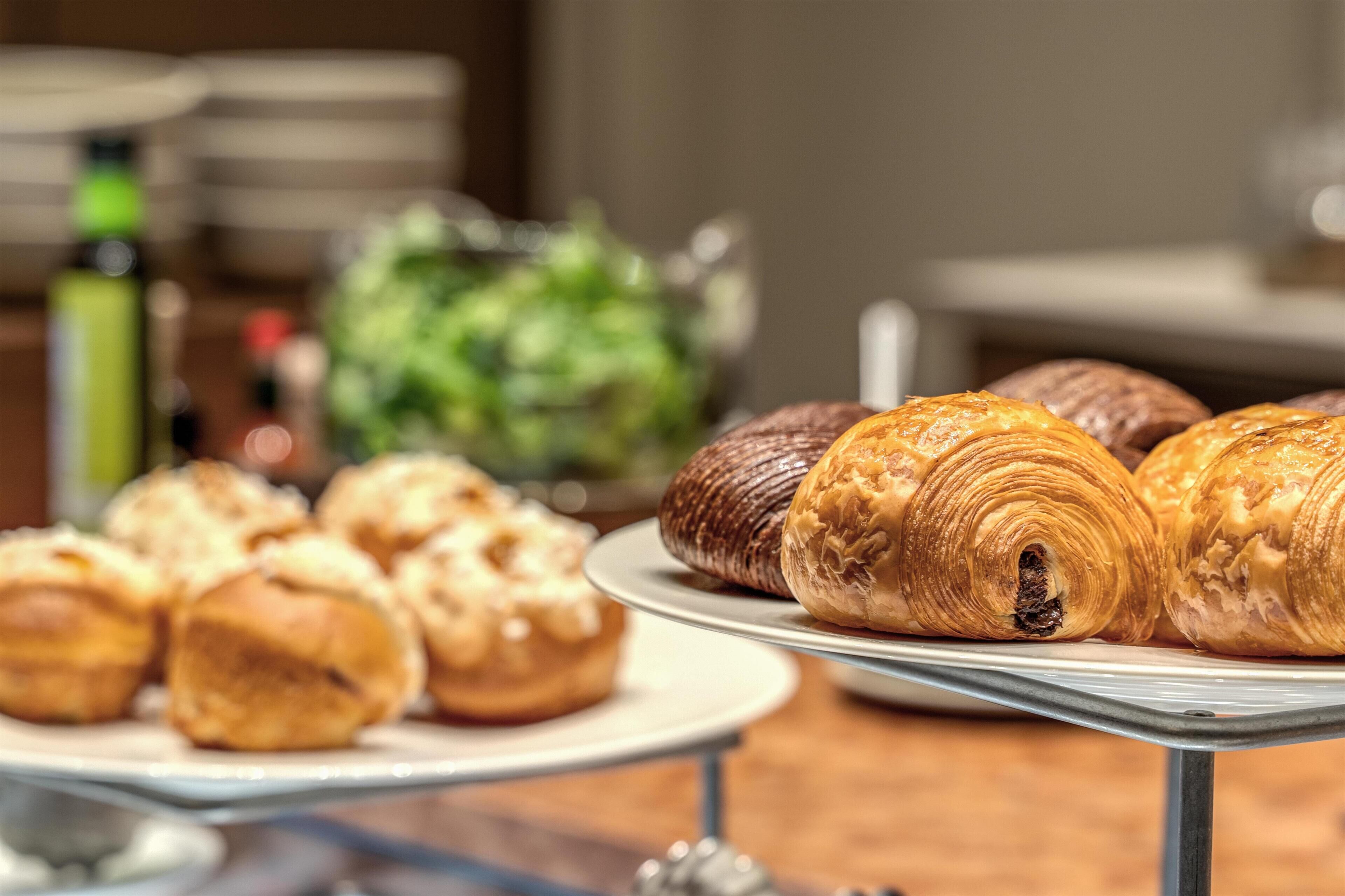 A display of assorted pastries on a metal stand.