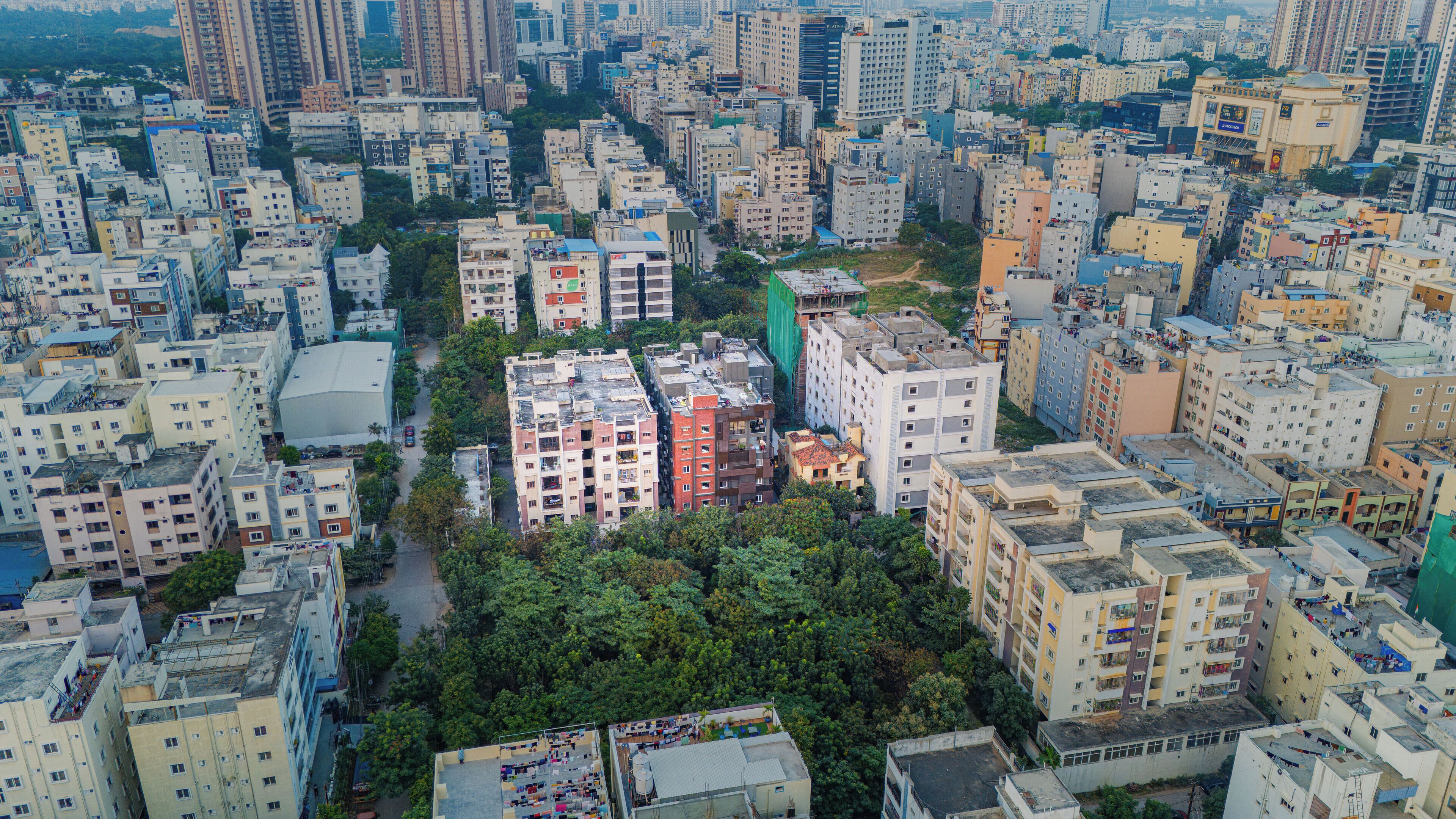 A densely packed urban area with high-rise residential buildings, narrow streets, and limited green spaces.