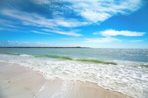A beach with waves, a clear sky, and a distant shoreline. - Beachfront 2B/2B Vacation Condo At Carlos Pointe Resort With Amazing Views! World Famous Sunsets! (Fort Myers Beach)
