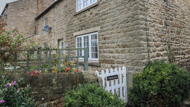 A stone building with a white picket fence, a sign reading "Daleholmme," and a satellite dish on the roof. - Daleholme (Barnard Castle)