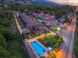 A residential area with houses, a swimming pool, and a road.
