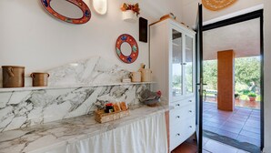 A bathroom with a marble countertop, a mirror, and a view of the outdoors. - Apartment 'Villa Ada' with Wi-Fi and Air Conditioning (Cozze)