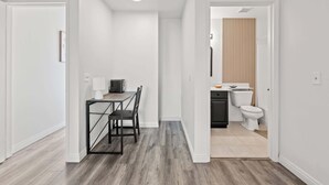 A modern kitchen with a black countertop, white cabinets, and a white toilet. - Near Dtla Gem Stylish Private Suite w King bed (Monterey Park)