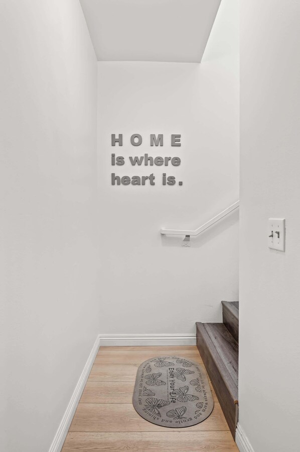 A staircase with a wall-mounted sign stating "HOME is where heart is." - Near Dtla Gem Stylish Private Suite w King bed (Monterey Park)
