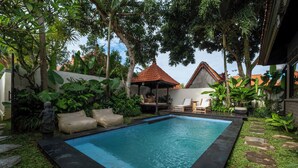 A swimming pool surrounded by lush greenery and a small gazebo. - Lux Villa With Outdoor Pool & Garden (Bali)