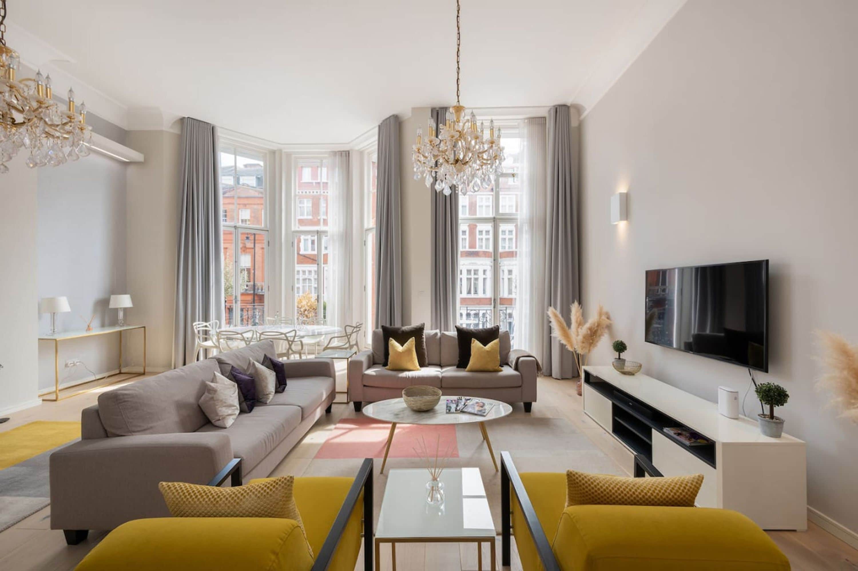 A modern living room with a sofa, coffee table, and TV.