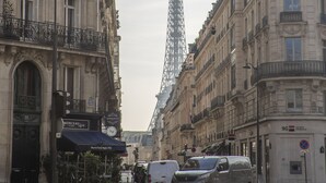 A street view with a prominent tower in the background, likely a famous landmark. - Luxury 4 Bed Residence - Next to Arc de Triomphe (Paris)