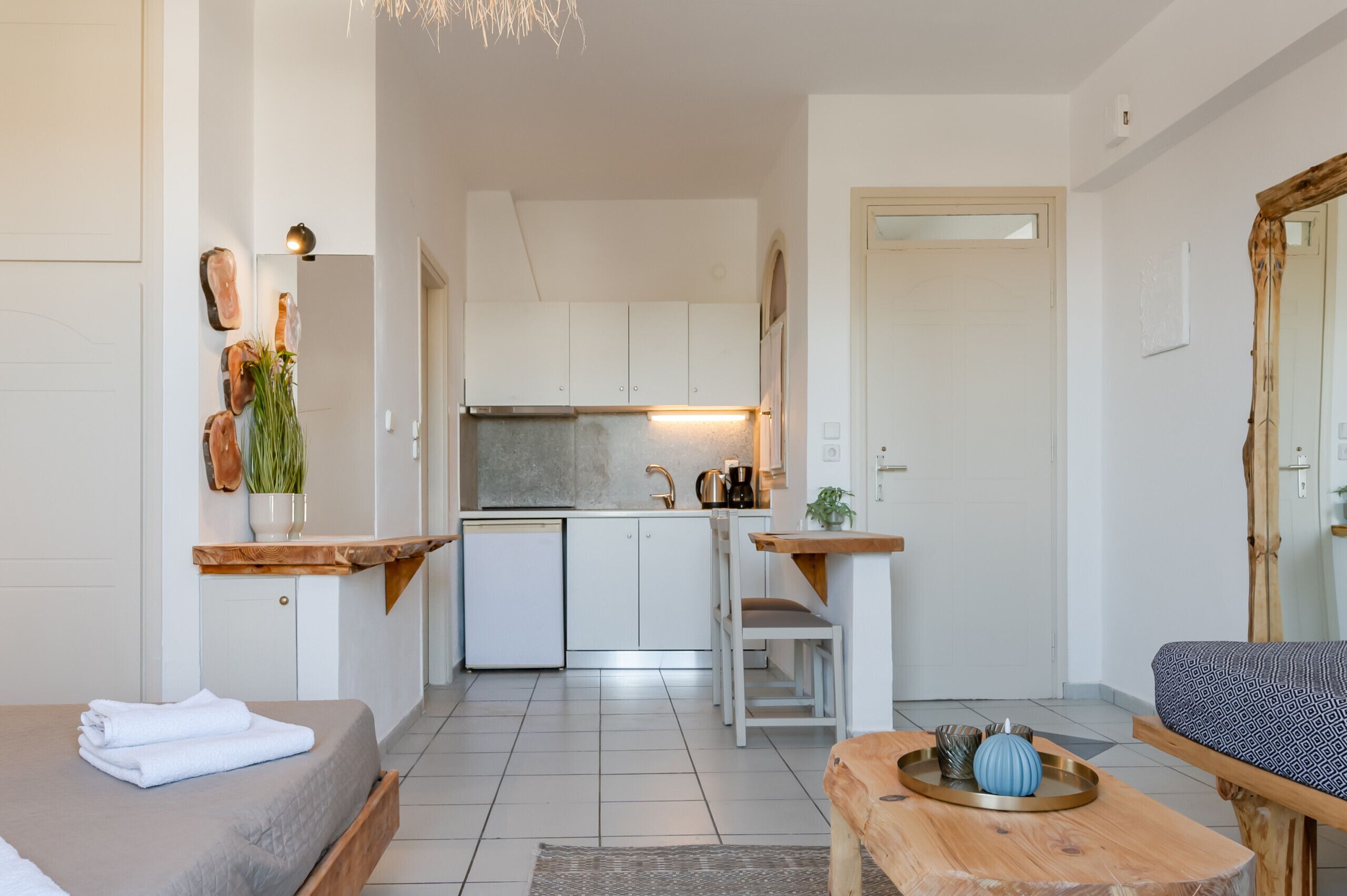 A compact living space with a kitchenette, a dining area, and a seating area.