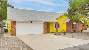 A two-story house with a garage, yellow exterior, and a brick foundation. - Sip, Hike, Relax! Cottonwood Home 4 Mi to Old Town (Cottonwood)