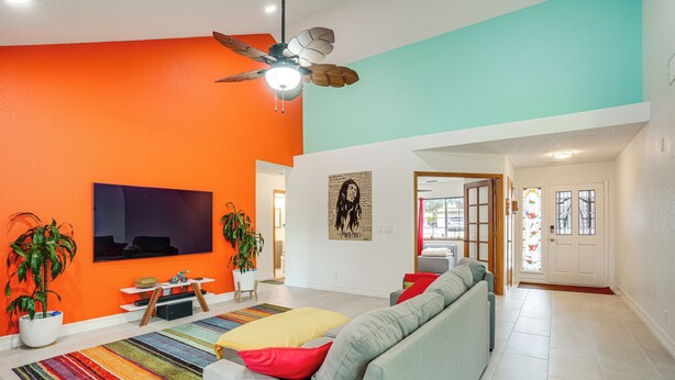 A modern living room with a large sofa, a flat-screen TV, a ceiling fan, and a colorful striped rug. - Sip, Hike, Relax! Cottonwood Home 4 Mi to Old Town (Cottonwood)