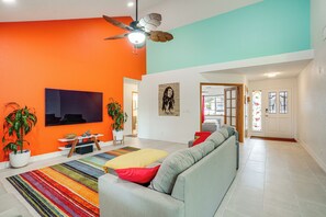 A modern living room with a large sofa, a flat-screen TV, a ceiling fan, and a colorful striped rug. - Sip, Hike, Relax! Cottonwood Home 4 Mi to Old Town (Cottonwood)