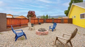 An outdoor patio with a fire pit, three Adirondack chairs, and a yellow building in the background. - Sip, Hike, Relax! Cottonwood Home 4 Mi to Old Town (Cottonwood)