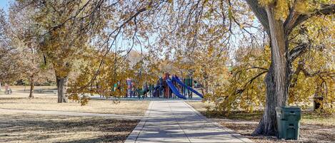 A park pathway leading to playground equipment.