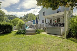 A two-story house with a covered porch, outdoor seating, and a swimming pool. - Hike & Explore Western Mass: Peaceful Studio (Palmer)