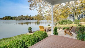 A covered deck with a view of a lake, a wooden chair, and a small table. - 2 Mi to Dtwn! Waterfront Gem on Wicomico River (Salisbury)