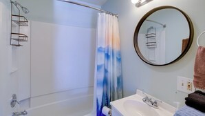 A bathroom with a shower, a sink, a mirror, and a towel rack. - Trail Town Usa! 2BD Cabin on Laurel Creek w/ Deck (Damascus)