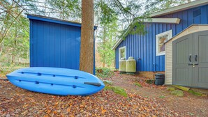 A blue building with a kayak, a tree, and a shed. - Ludlow Cabin on Lake Pauline w/ Outdoor Fire Pit (Ludlow)