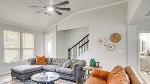 A living room with a sectional sofa, a coffee table, and a fireplace. - Close to Energy Giants! 3,300-sq-ft Midland Home (Midland)