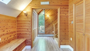 A wooden interior with a bench, a sign reading "Lake House," and a view through a door. - Game Room & Resort Perks! Split Rock Retreat (Lake Harmony)